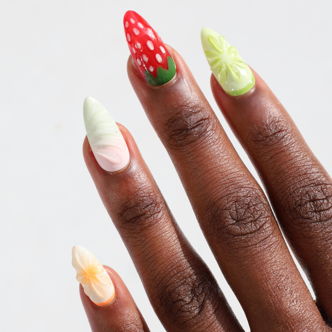 Angled photo of dark skinned hand with Fruit Chunk 3D Nails