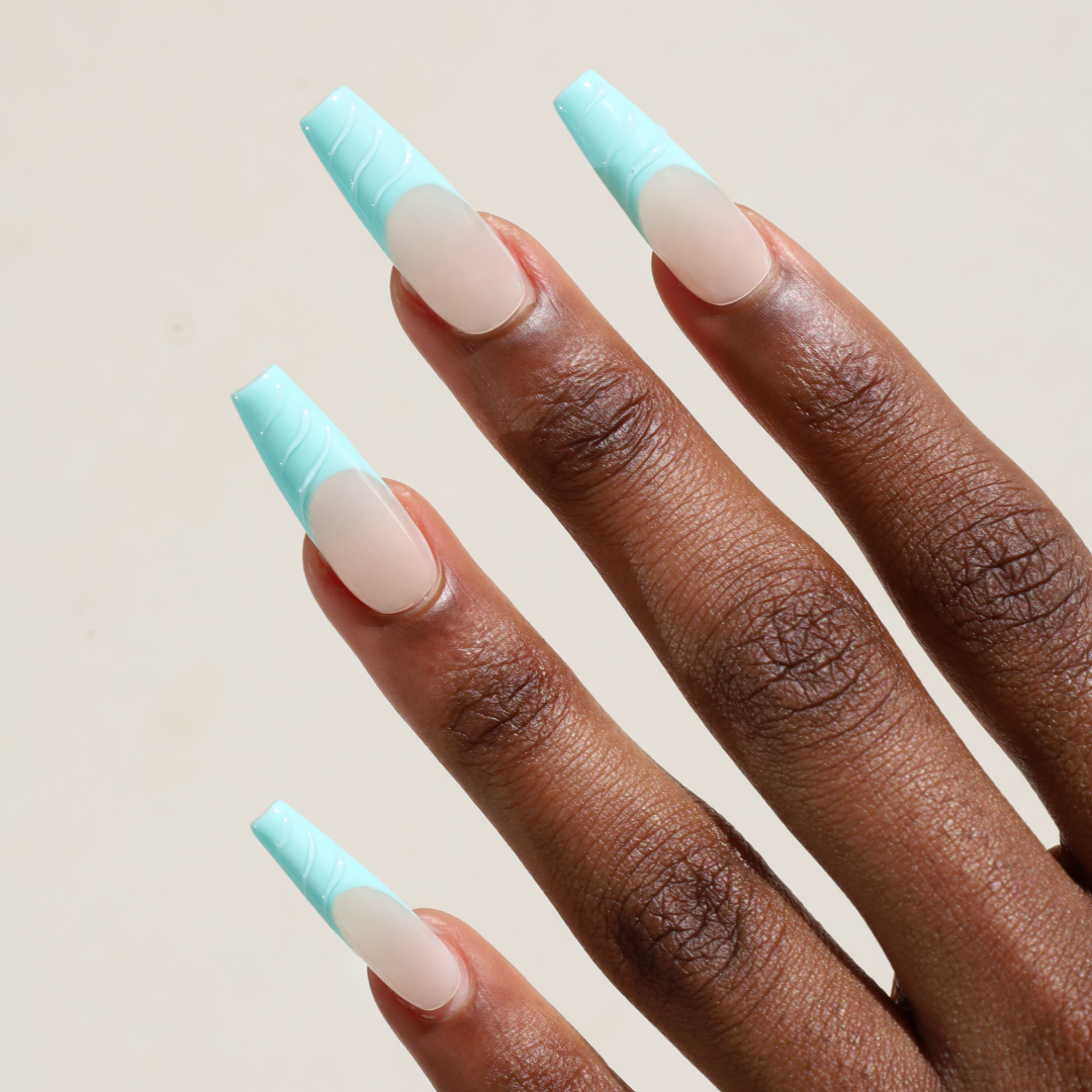 Angled photo of dark skinned hand with Mermaid Coffin Nails