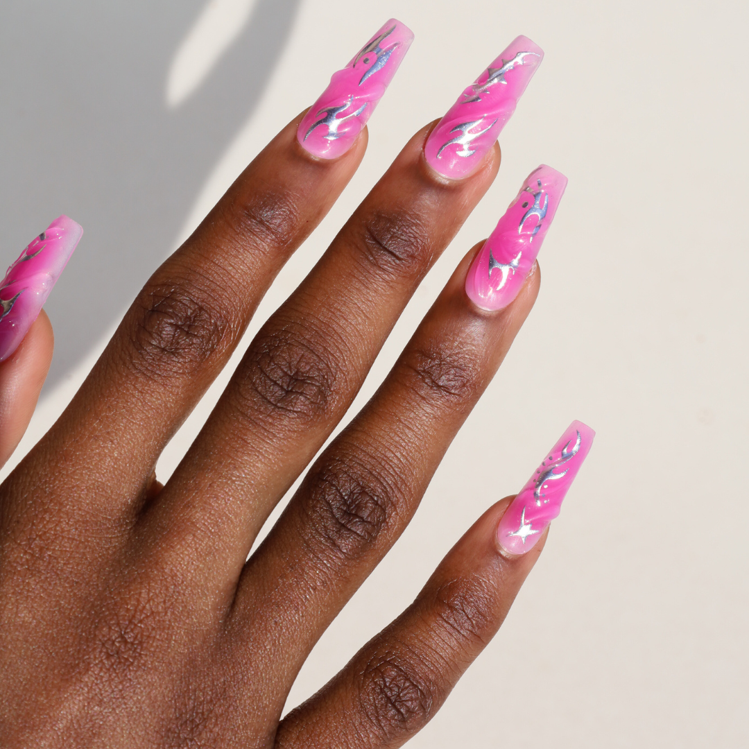 Angled photo of dark skinned hand with Chrome Pink Coffin Nails