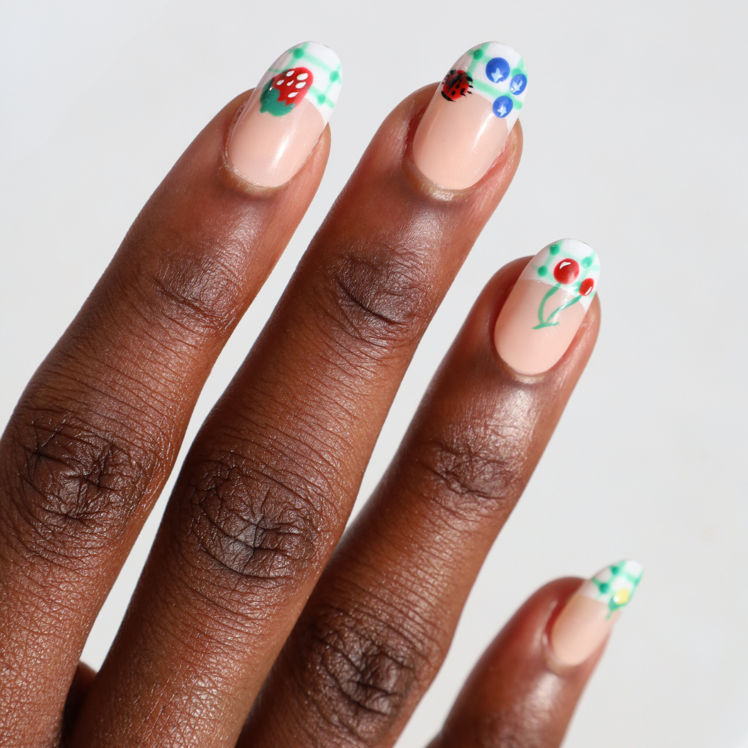 Angled photo of dark skinned hand with Picnic Fruit Nails