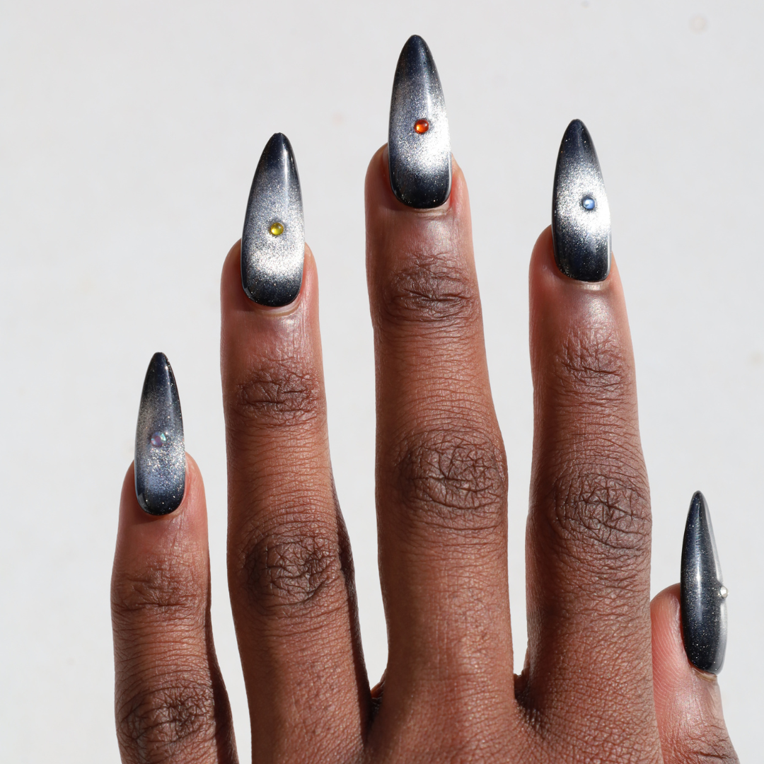 Dark skinned hand with Black Cateye Gem Nails