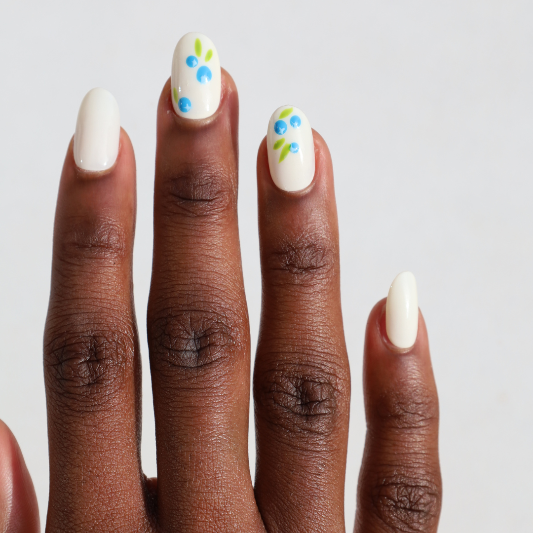 Dark skinned hand with Blueberry Nails